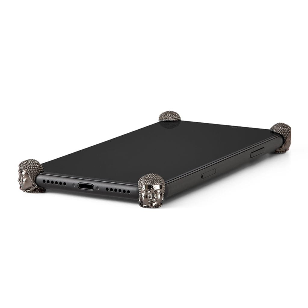 Carbon Buddha ICONS installed on all four corners of a bare iPhone 11