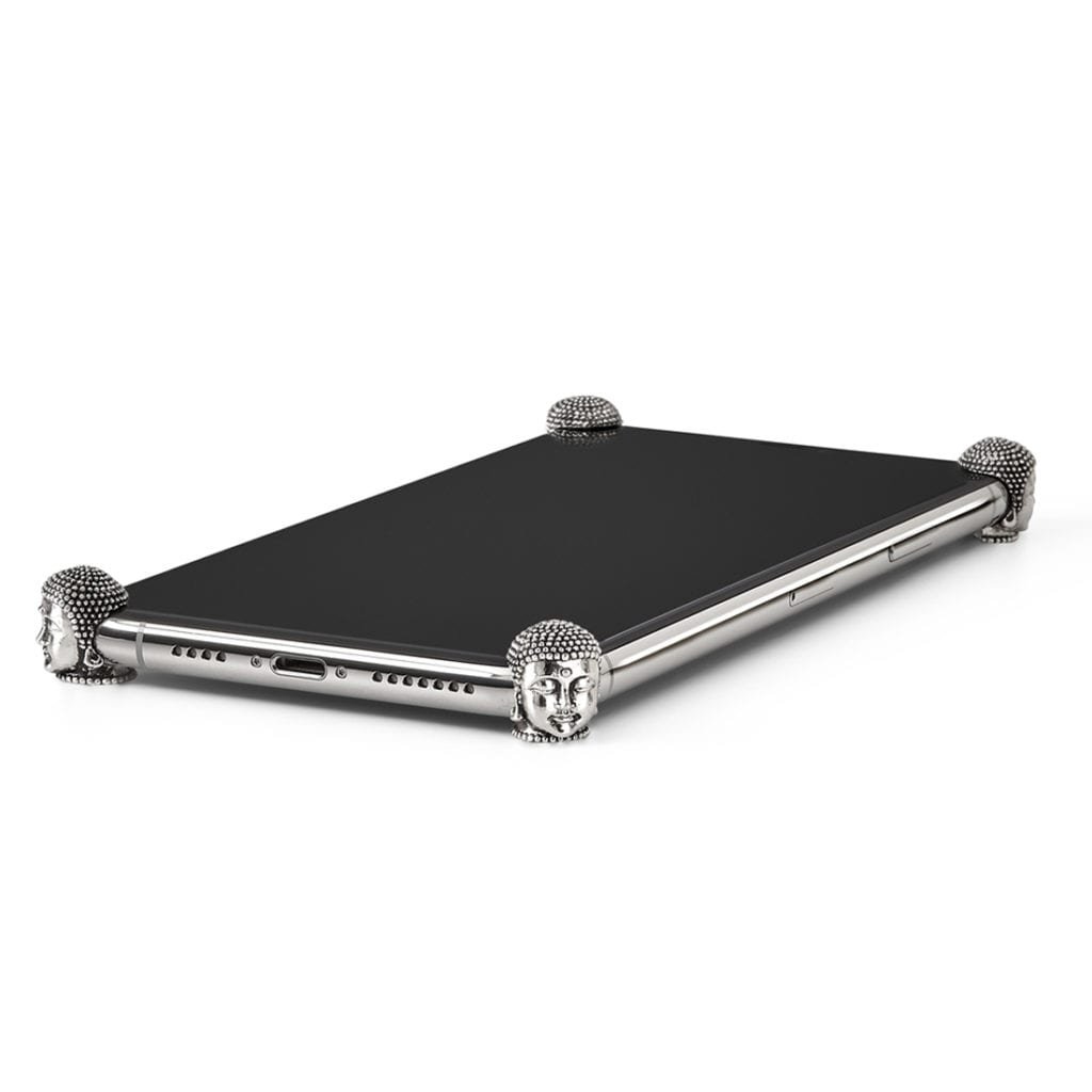 Silver Buddha ICONS installed on all four corners of a bare iPhone 11