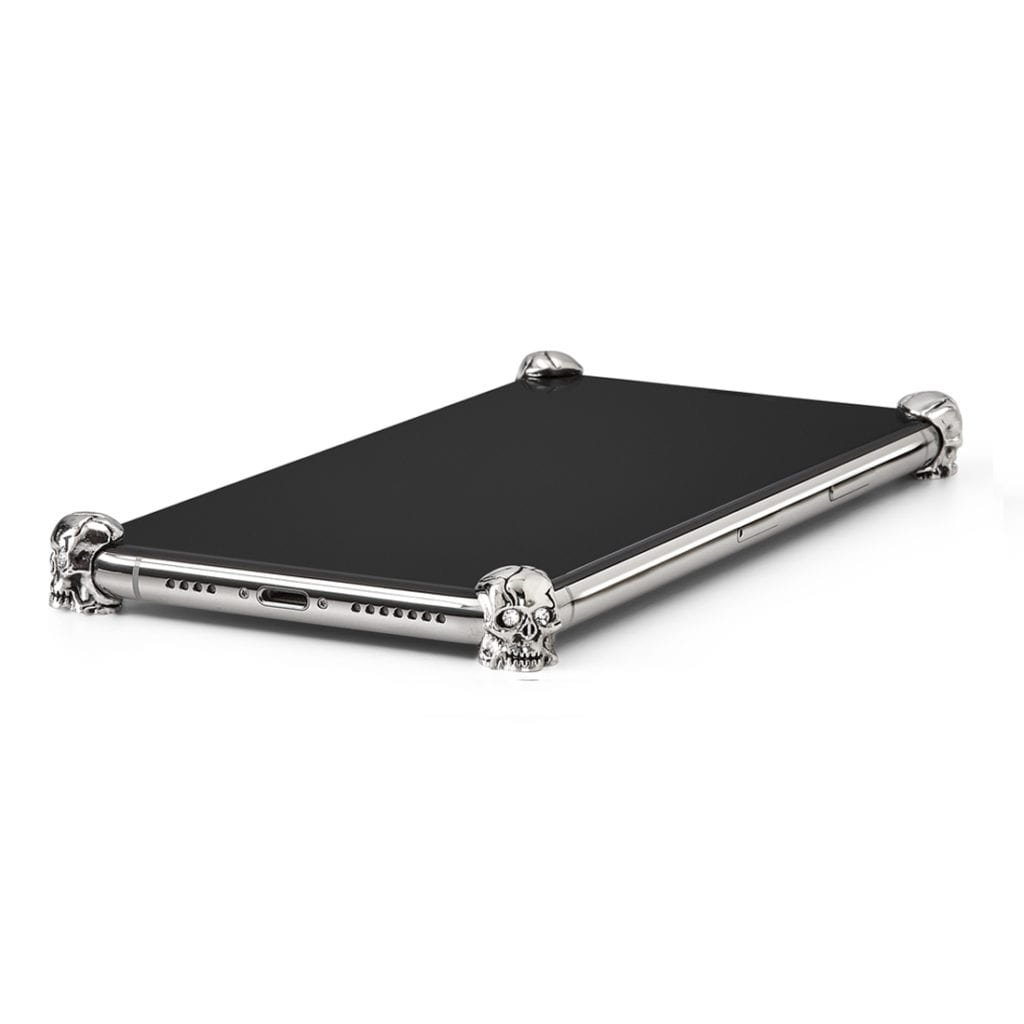Silver Skull ICONS installed on all four corners of a bare iPhone 11
