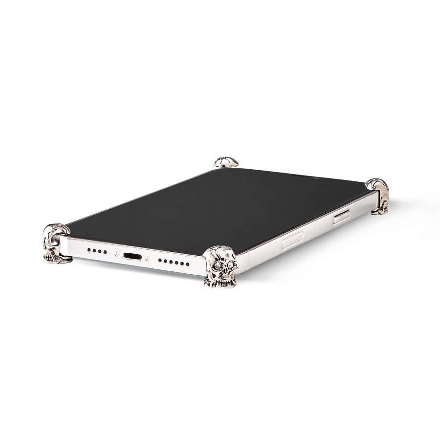 Silver Skull ICONS installed on all four corners of a bare iPhone 14 Pro / Pro Max