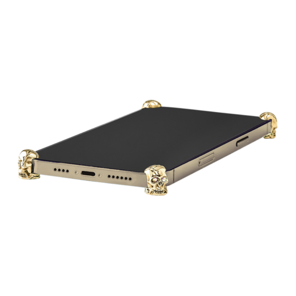 Gold Skull ICONS installed on all four corners of a bare iPhone 17