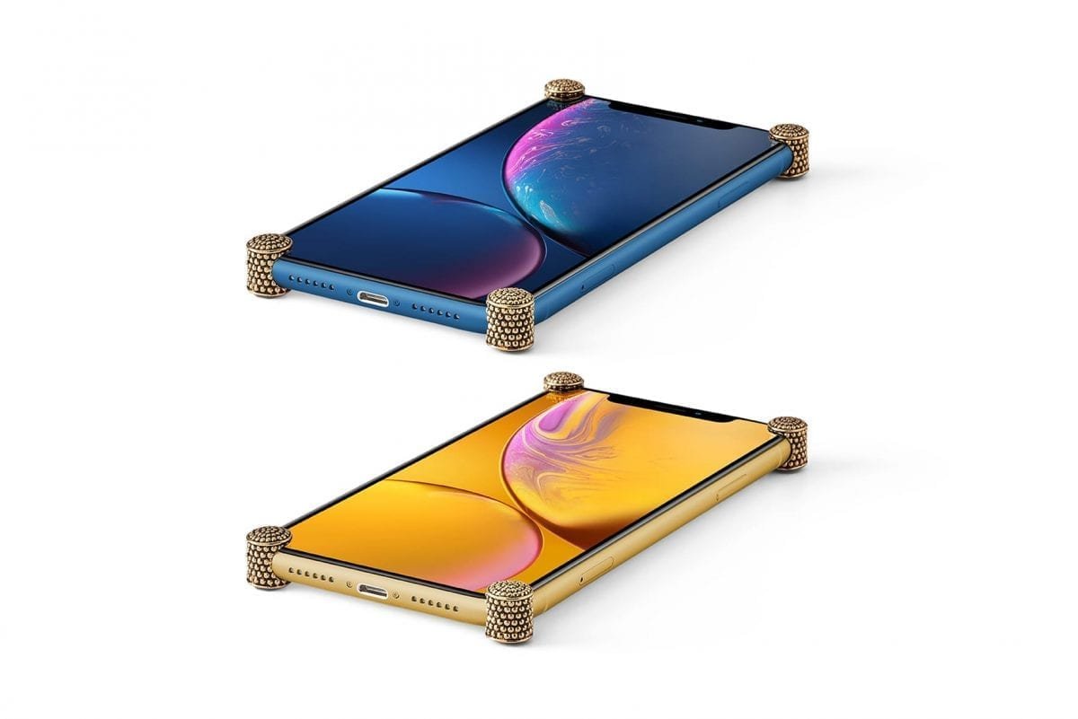 Gold Dragon ICONS installed on all four corners of a bare iPhone XR