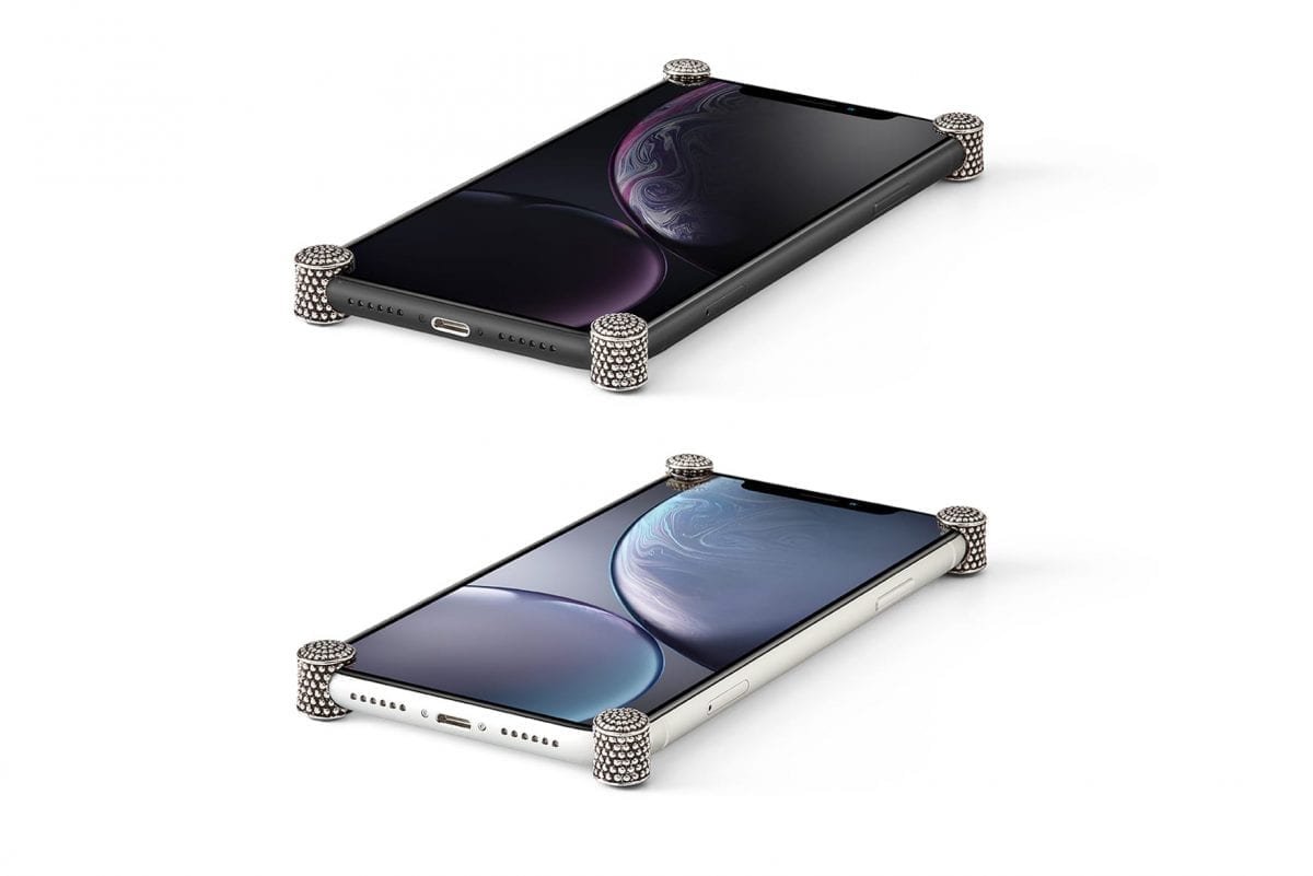 Silver Dragon ICONS installed on all four corners of a bare iPhone XR
